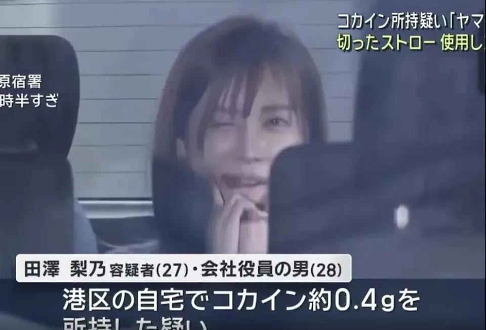 田澤梨乃被移送時曾面對媒體鏡頭露出笑容、比出YA手勢，引發日本網友討論。（圖／翻攝自日網）