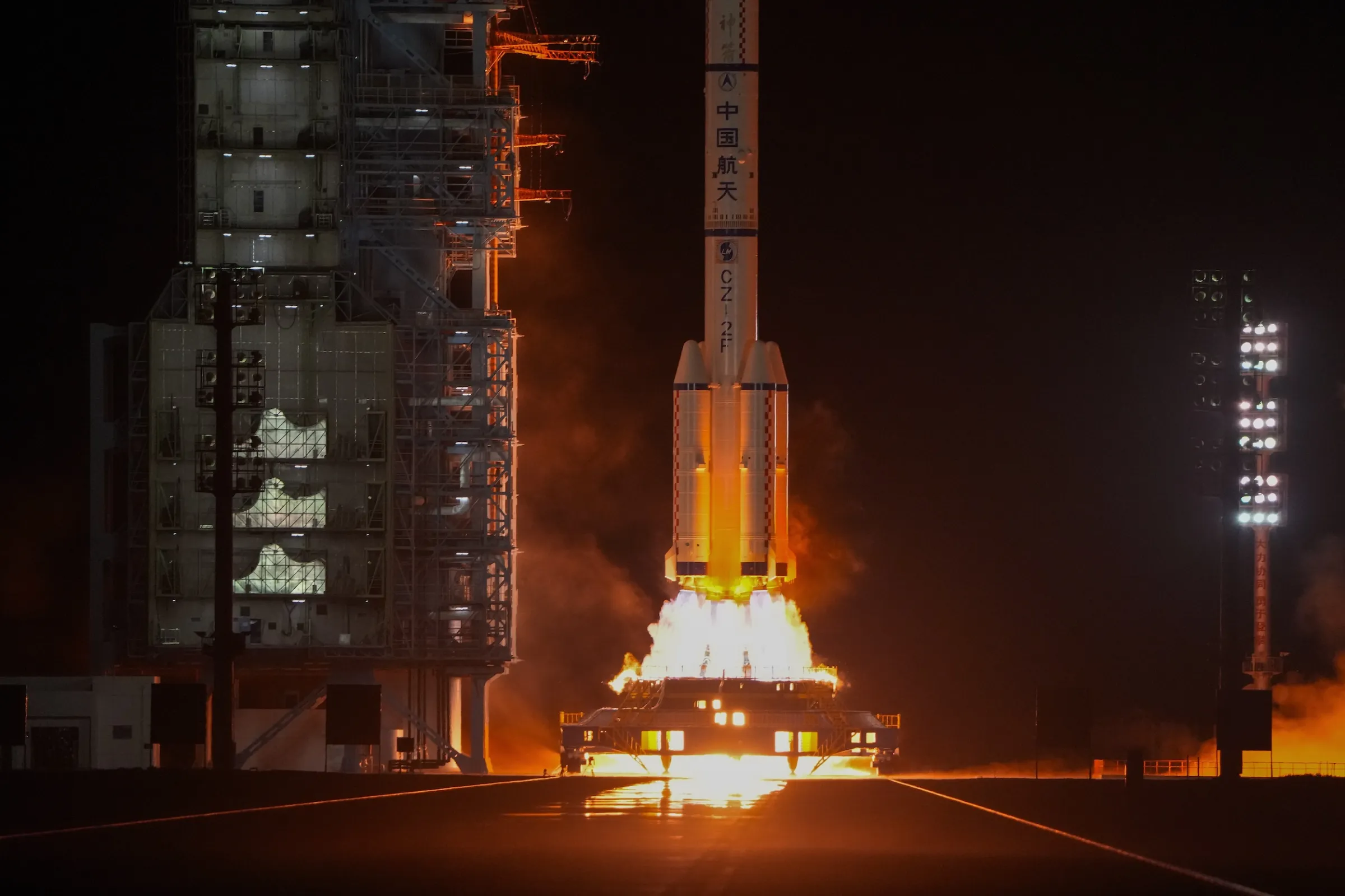 China has been racing the United States in space, launching satellites atop rockets like this Long March vehicle carrying the Shenzhou 18 spacecraft from the Jiuquan Satellite Launch Center in April 2024. (AP)