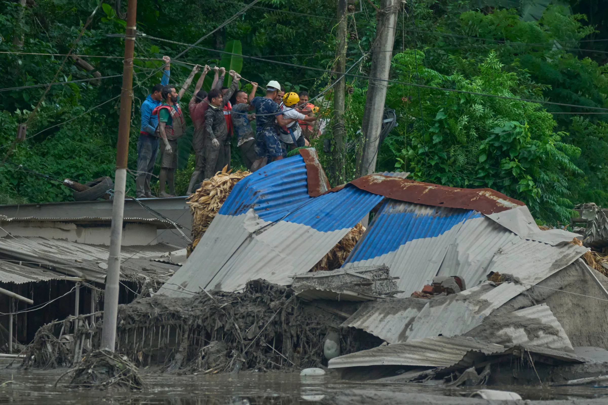 Rescuers lay a rope way to look for surivors after flash flooding along the Trishuli River in Nepal's Nuwakot district, Wednesday, Aug. 26, 2026.(AP)